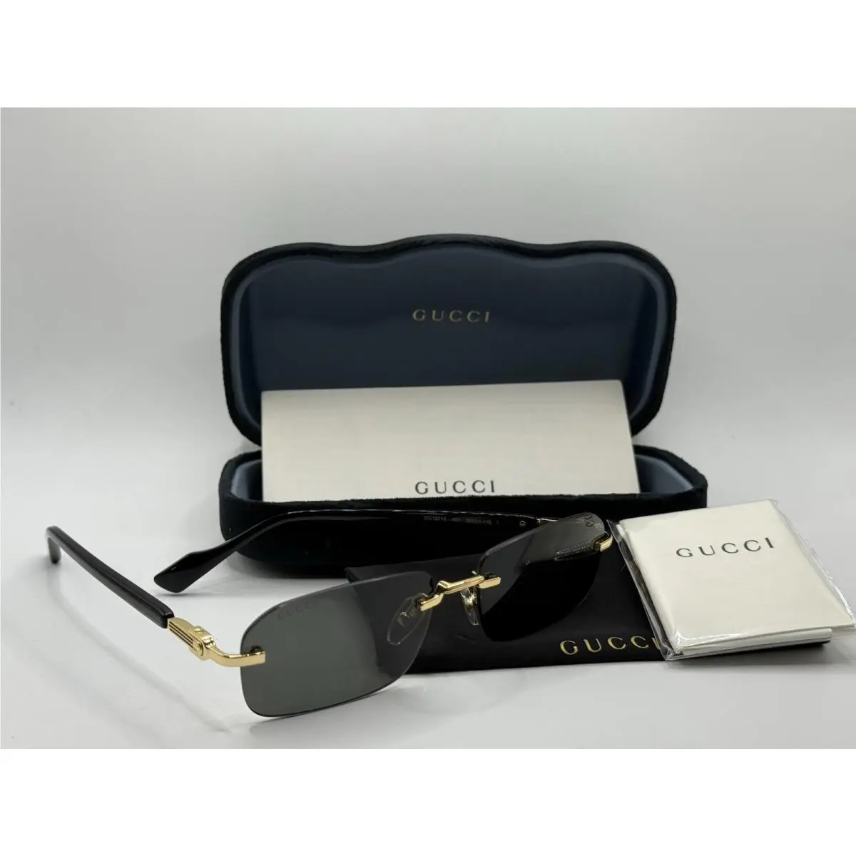 Gucci GG1221S 001 Sunglasses Black and Gold with Gray Lenses