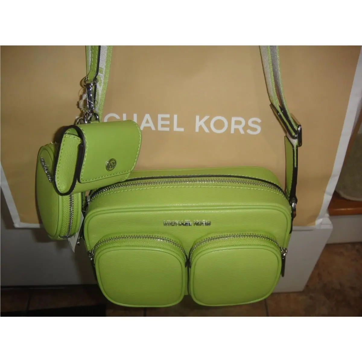 Michael Kors Jet Set Med Pkt Leather X Body with Tech Attached.msrp
