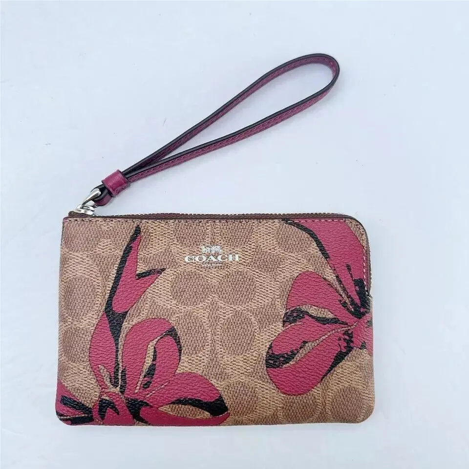 Coach Corner Zip Wristlet In Signature Canvas with Bow Print CZ440/CZ441