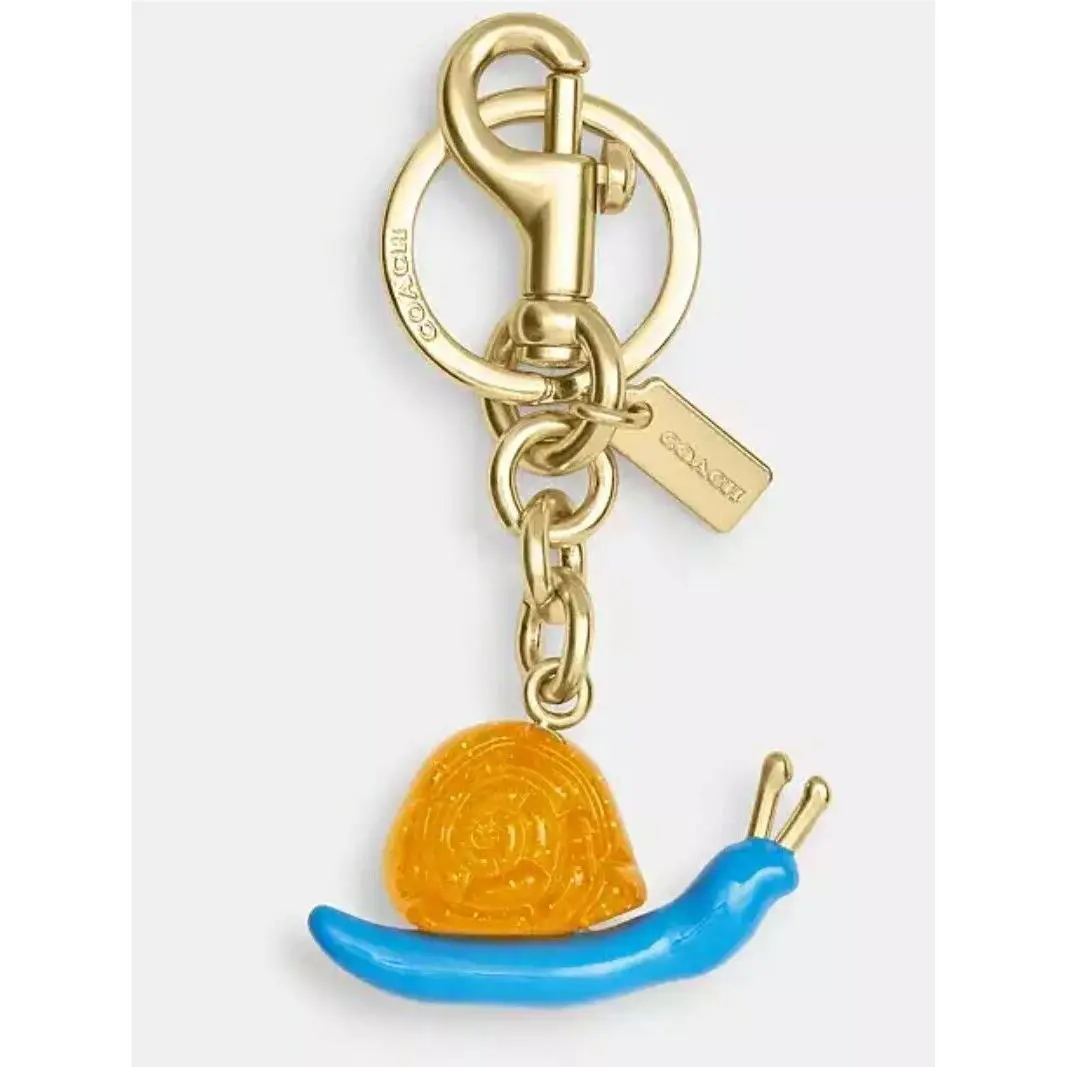 X Observed BY US Orange Snail Gold Keychain Bag Charm by Coach