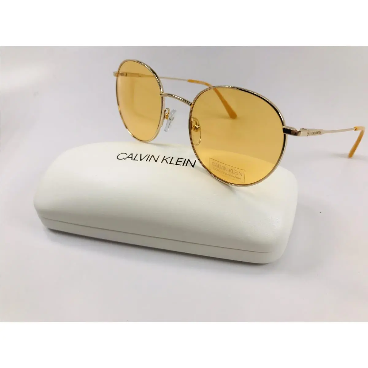 Calvin Klein CK18104S 717 Round Gold Maize Sunglasses with Case