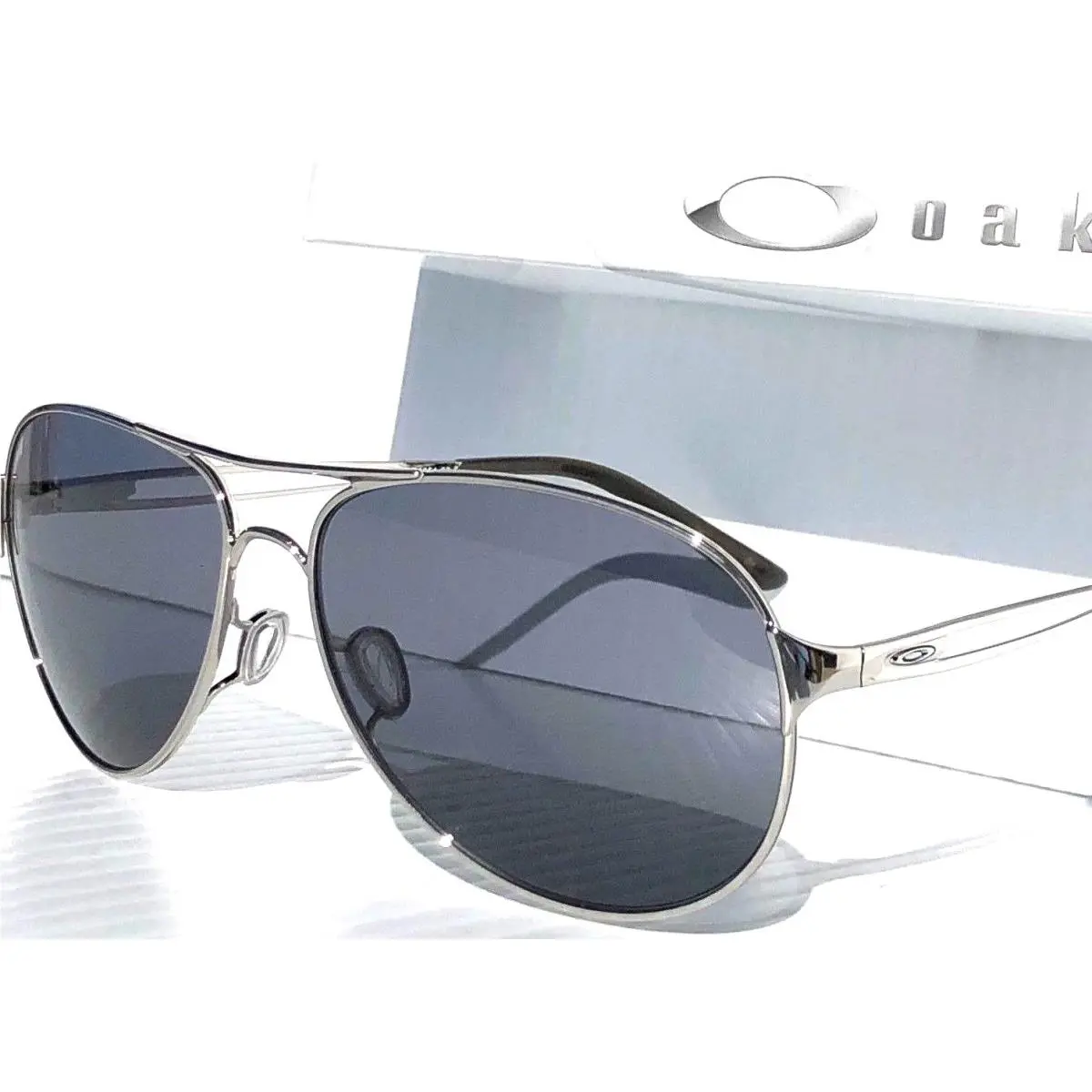 Women`s Aviator Caveat Silver 60mm Grey Iridilum Sunglass 4054-02 by Oakley