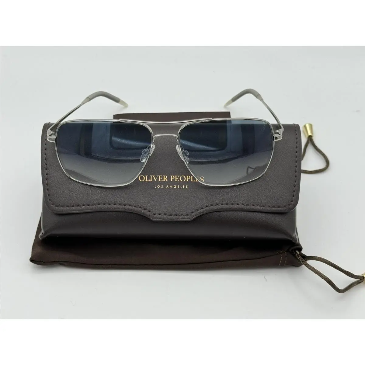 Clifton OV1150S 50363F -silver/ Clear Gradient Blue Photocromic by Oliver Peoples