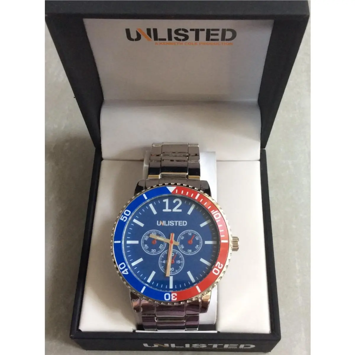 Kenneth Cole Unlisted Men`s Watch Round Pepsi Dial ON Black Silver Linked Band
