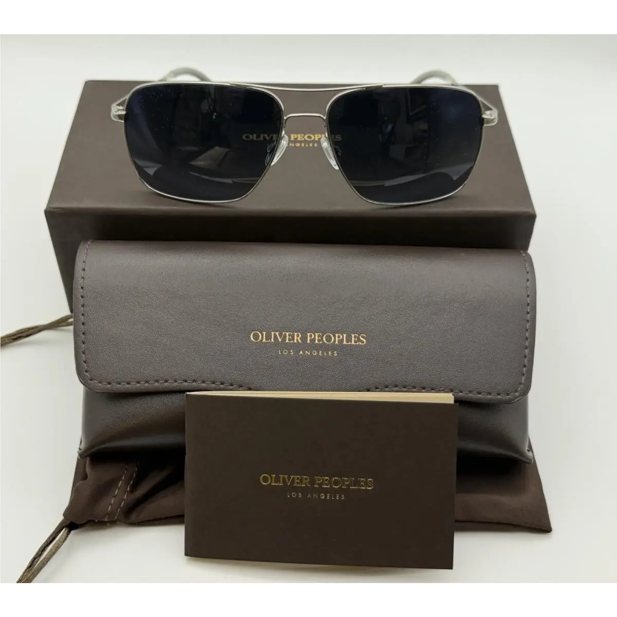 Clifton OV1150S 5036S3 -silver / Clear Gradient Blue Polarized by Oliver Peoples