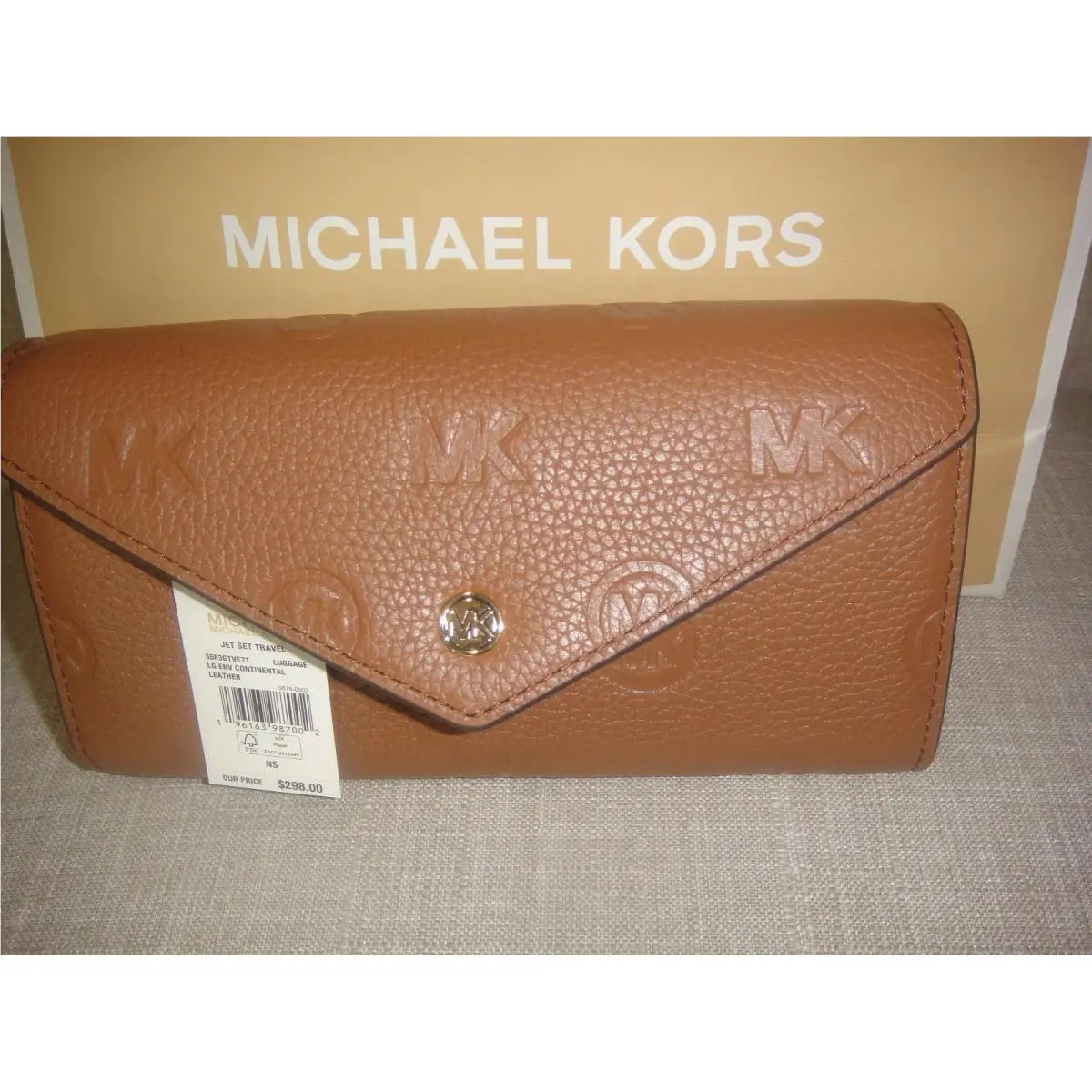 Michael Kors Jet Set Travel Large Logo Embossed Leather Envelope Wallet.$298.00