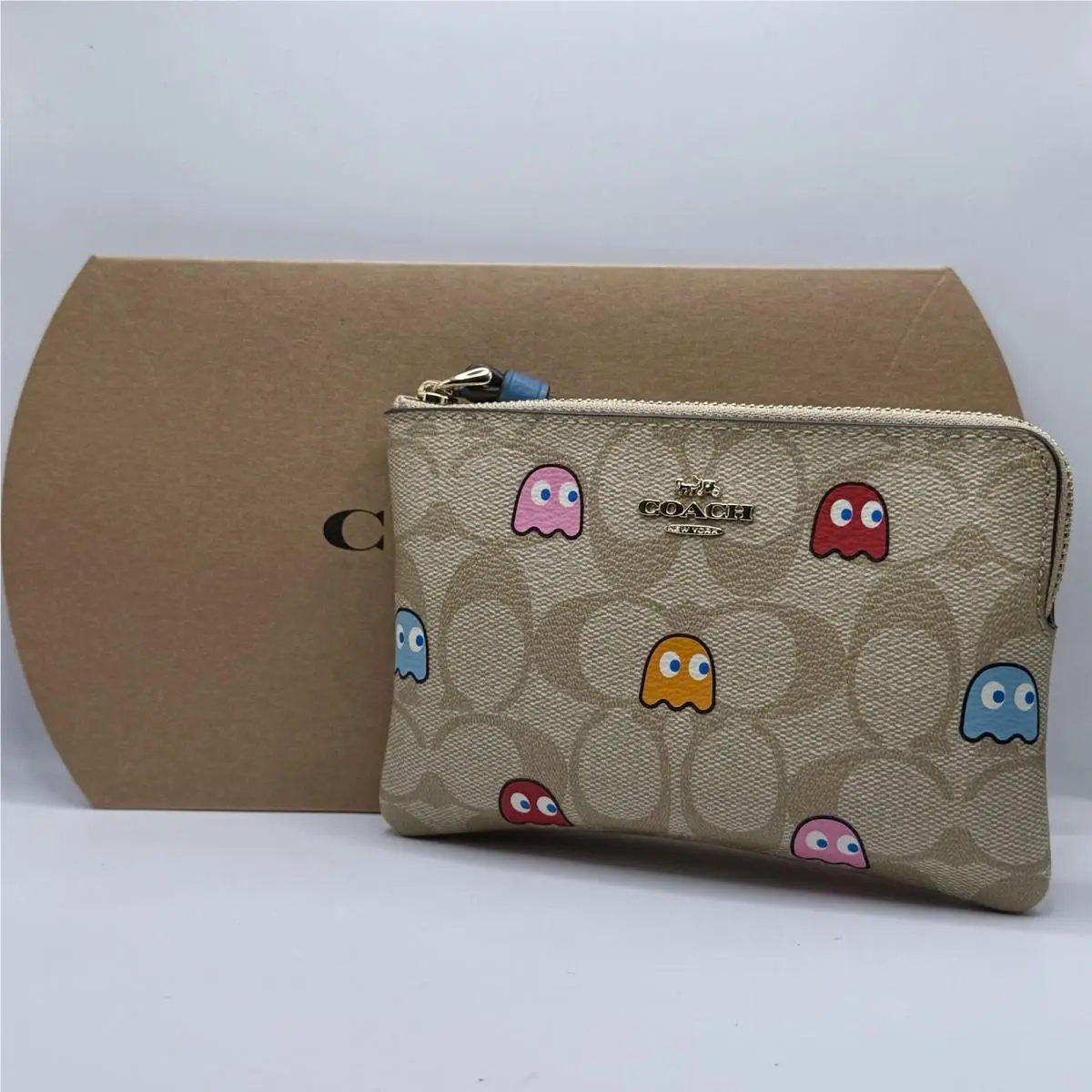 X Pac-man™ Corner Zip Wristlet In Signature Canvas with Ghosts Print by Coach