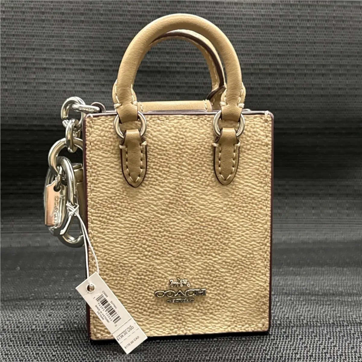 North/south Mini Tote Bag Charm In Signature Canvas CX069 by Coach