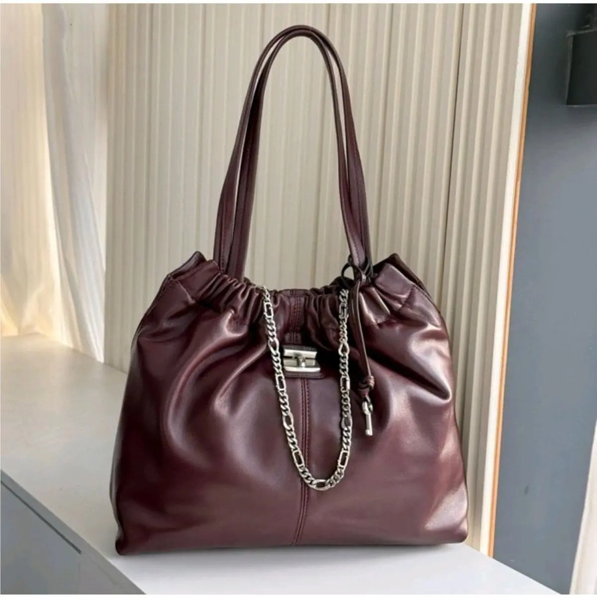 The Cristina Chain-embellished Drawstring Leather Leather Tote Dark by Marc Jacobs