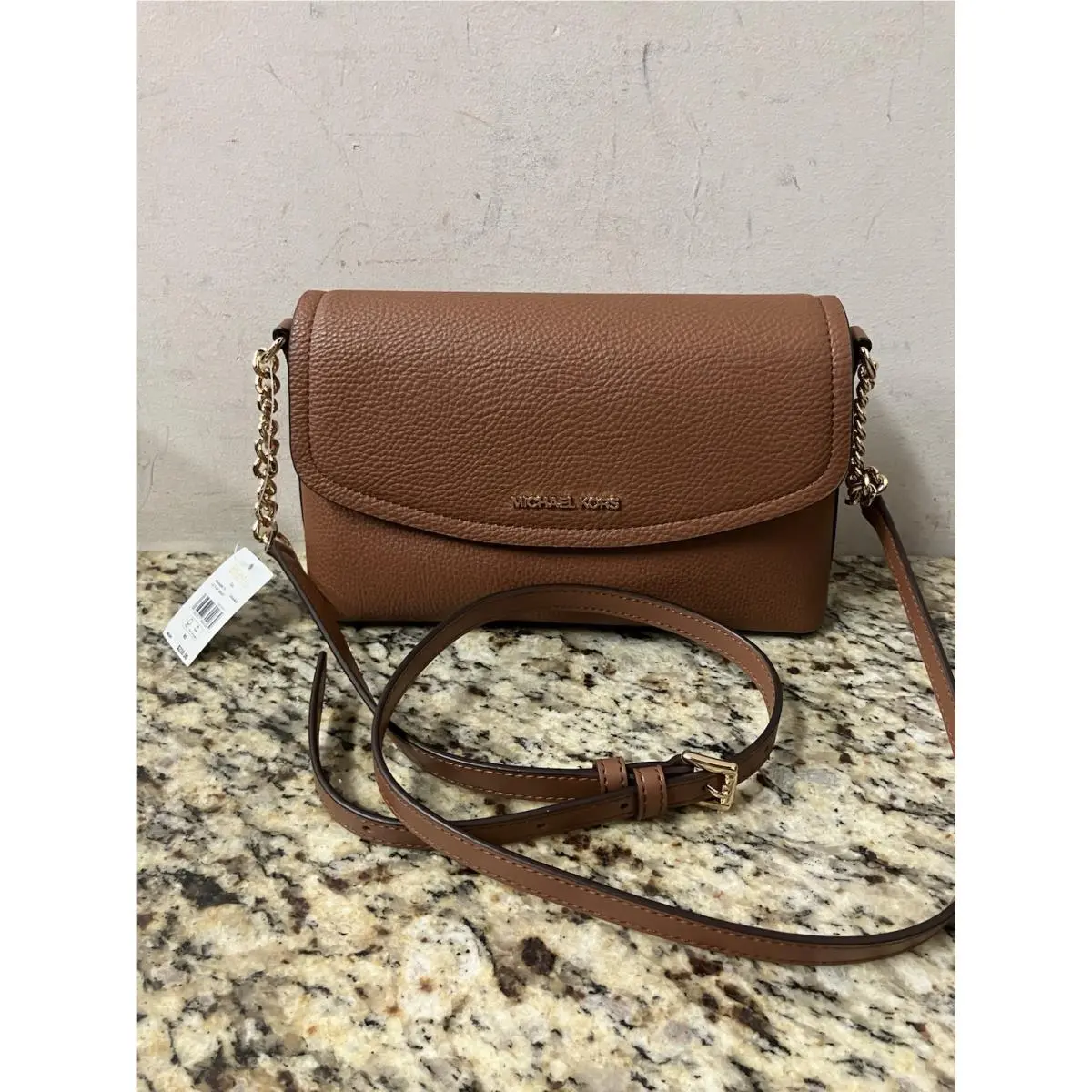 Michael Kors Ida LG Flap Xbody Brown Features a Gold-toned Cha