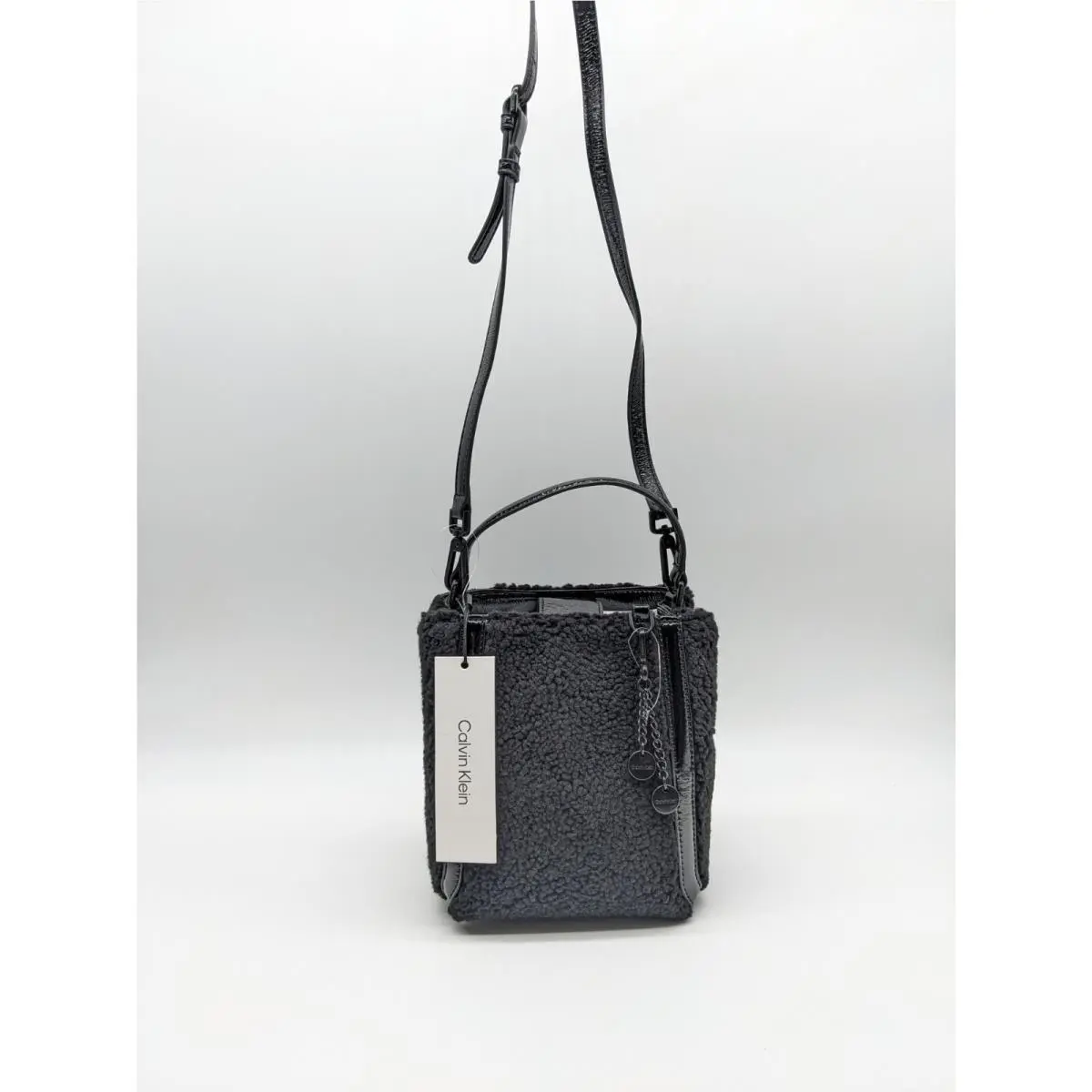 Calvin Klein Astatine Sherpa Trim Patent Leather Mini Crossbody in Black
