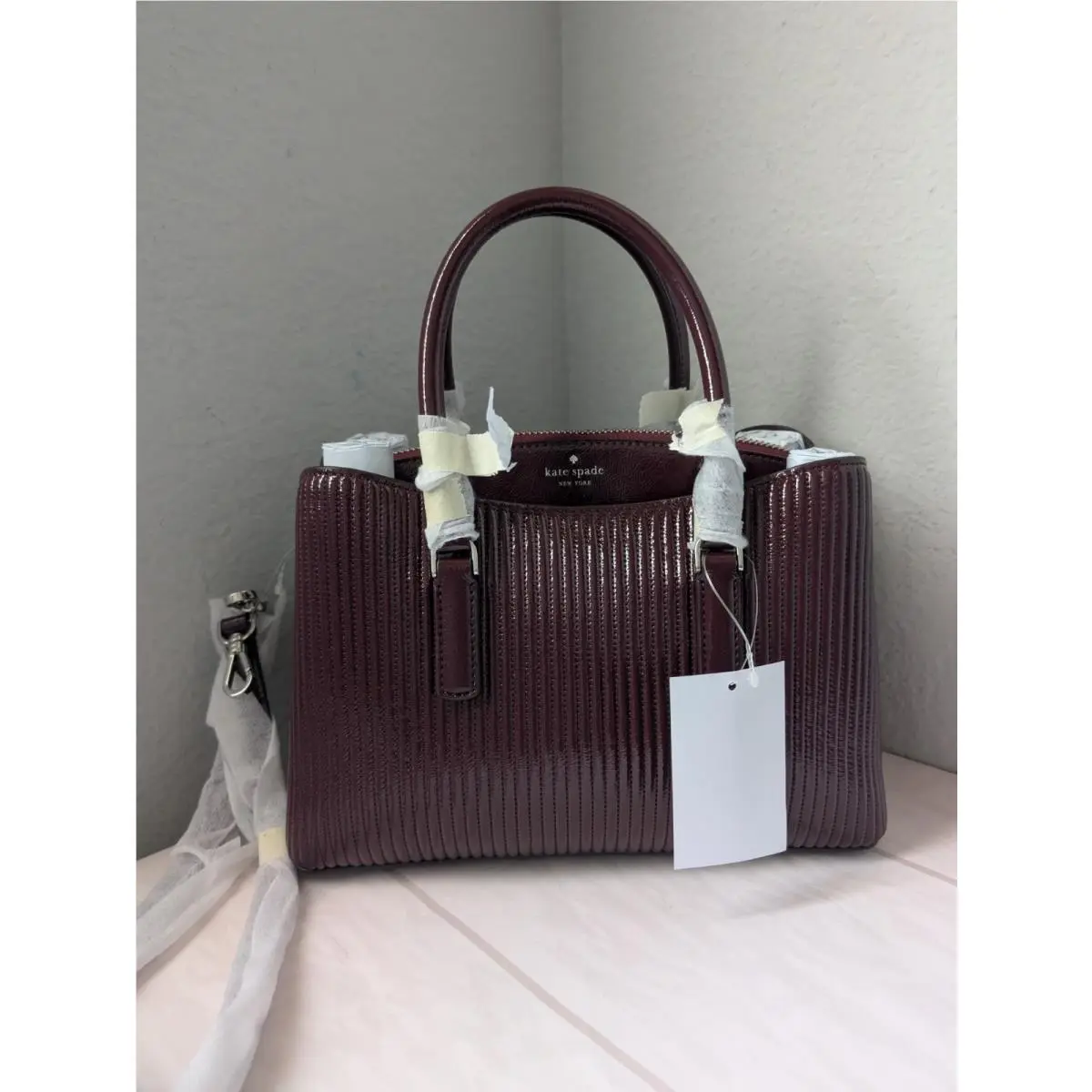 KP176 Thompson Street Shiny Quilted Small Satchel Bag In Grenache by Kate Spade