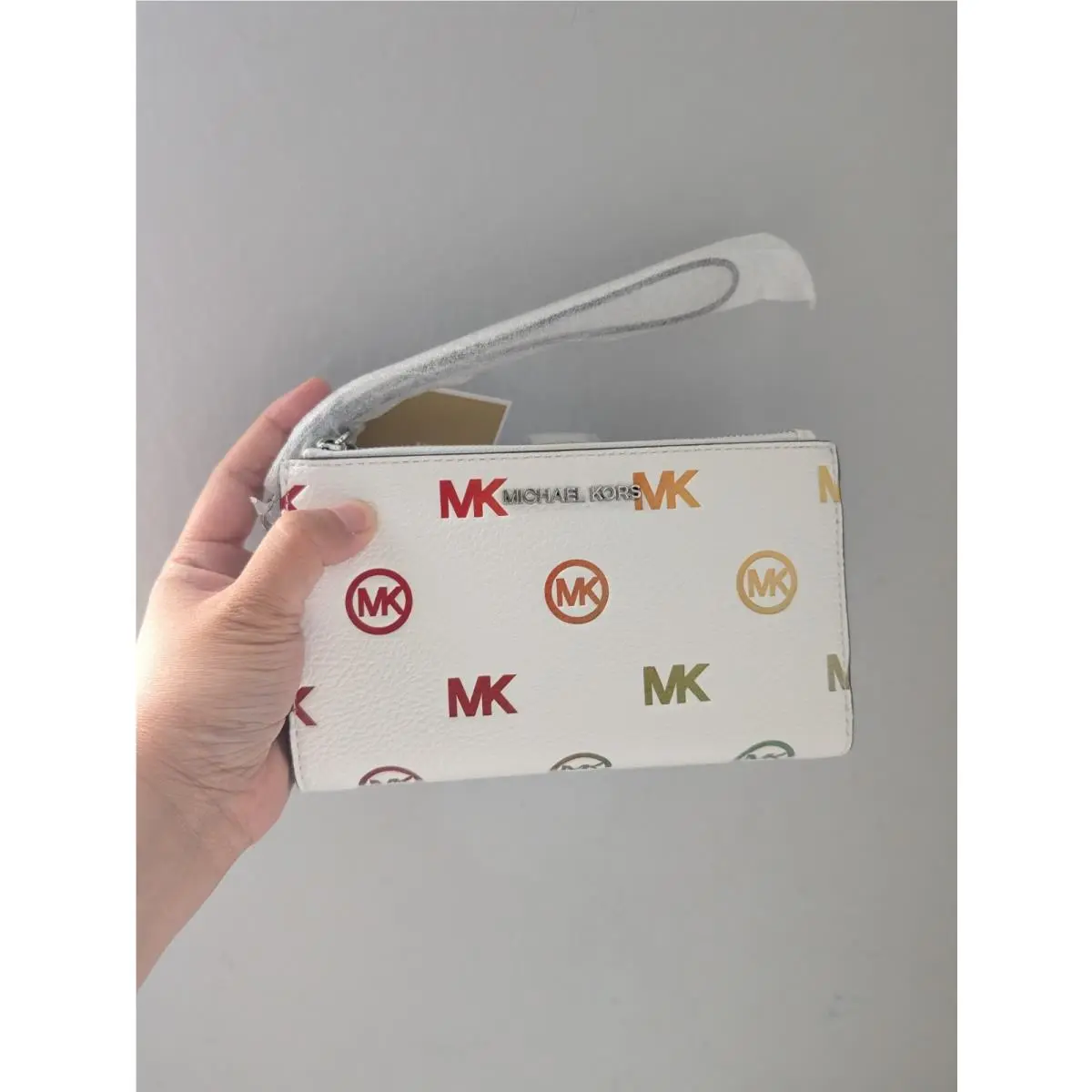 Jet Set Travel Rainbow Logo Embossed Wristlet In Optic White by Michael Kors