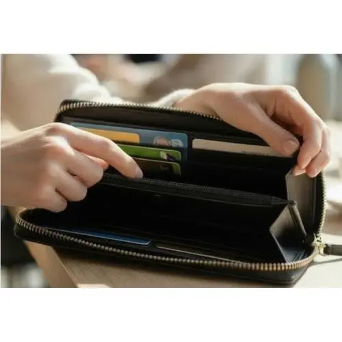 Large Pebbled Leather Zip Around Wallet in Black - Pockets Galore by Kate Spade
