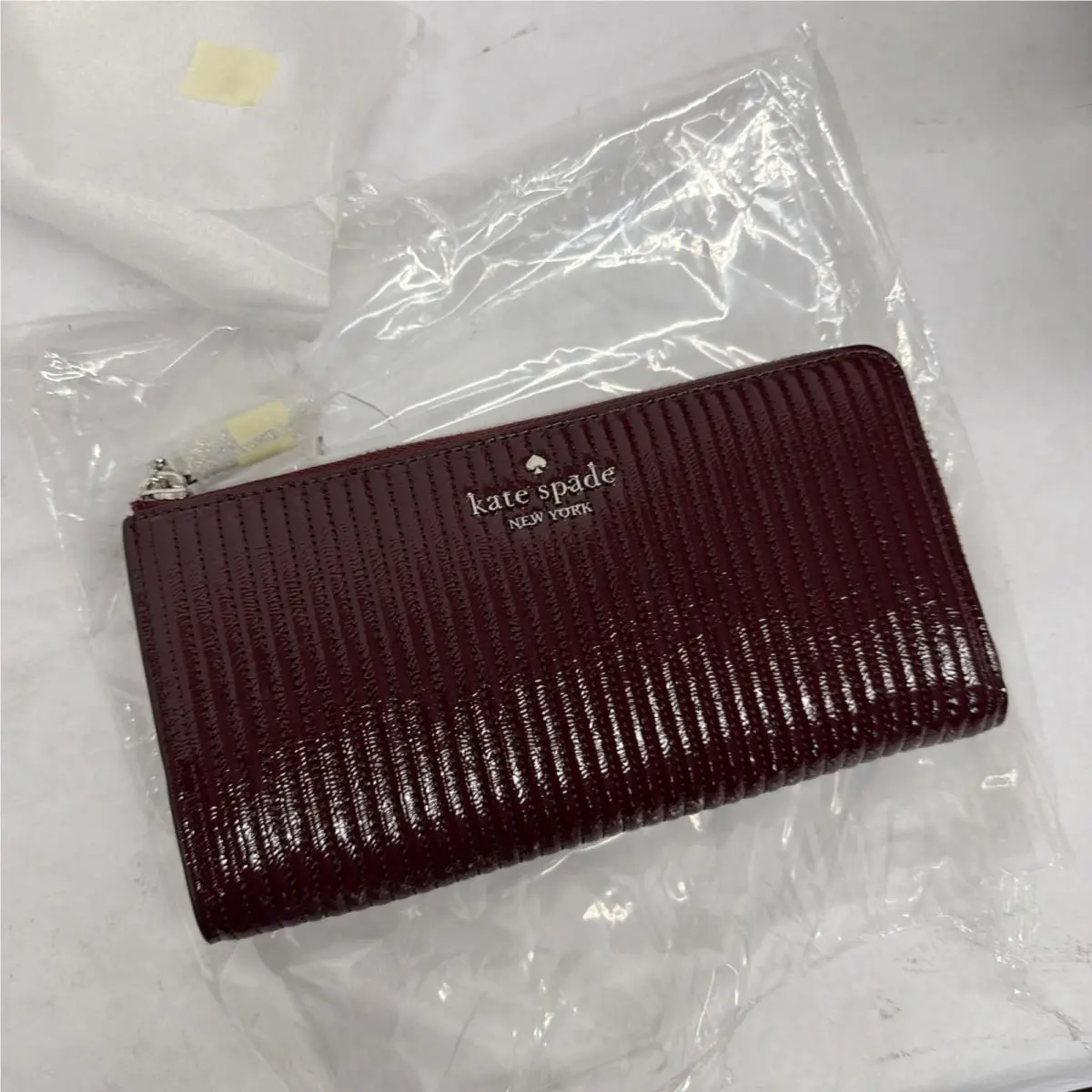 Shiny Quilted Patent Large Slim L-zip Wallet Grenache by Kate Spade
