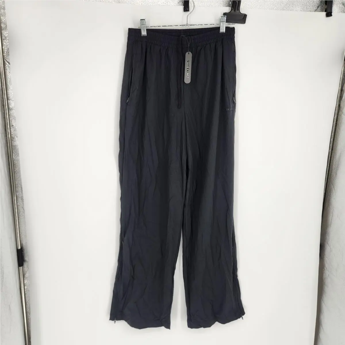 skims Obsidian XS Woven Nylon Track Pants by Nike