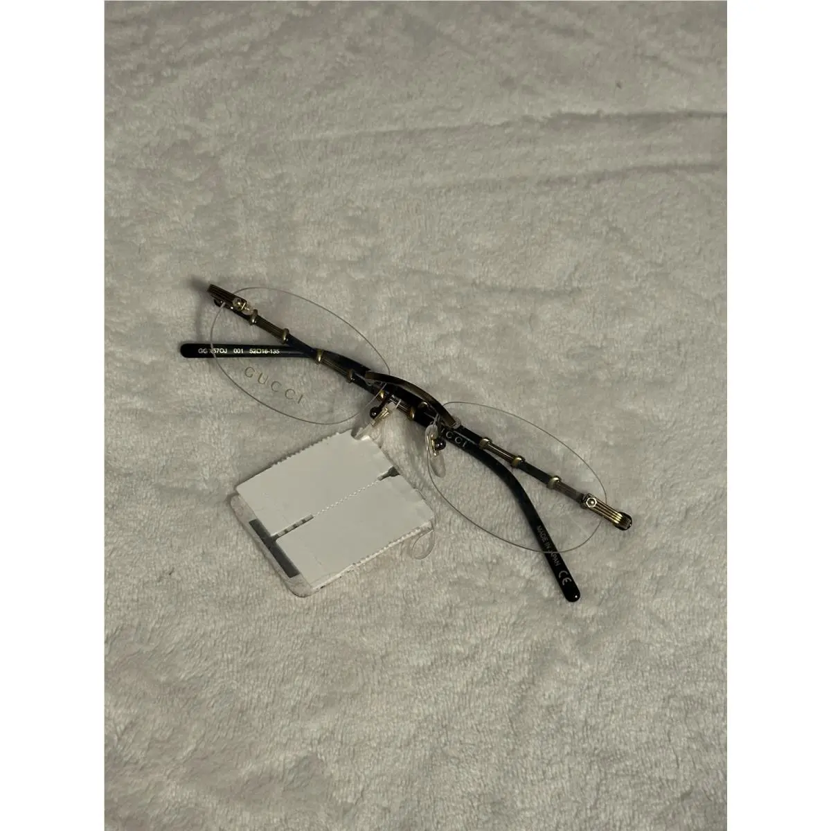 Black and Antique Gold Rimless Eyewear and Clear Lenses by Gucci