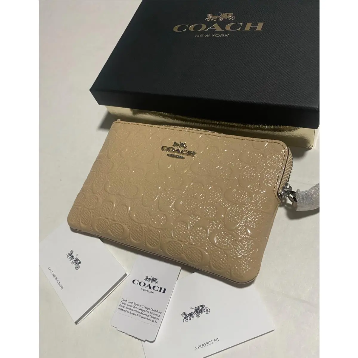 Coach Corner Zip Wristlet In Signature Debossed Patent Leather Color Chalk