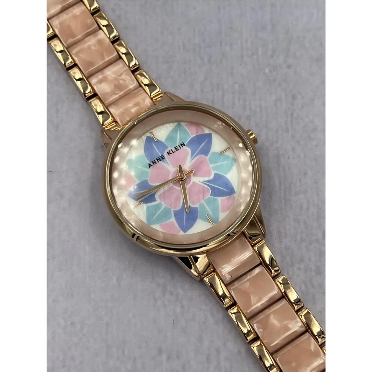 AK/4006PKRG Women`s White Floral Mop Dial Analog Bracelet Watch by Anne Klein