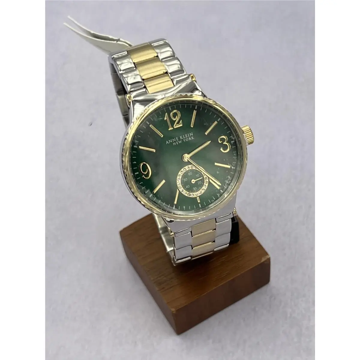 12/2341GMTT Women`s Green Mop Dial Analog Two Tone Bracelet Watch by Anne Klein